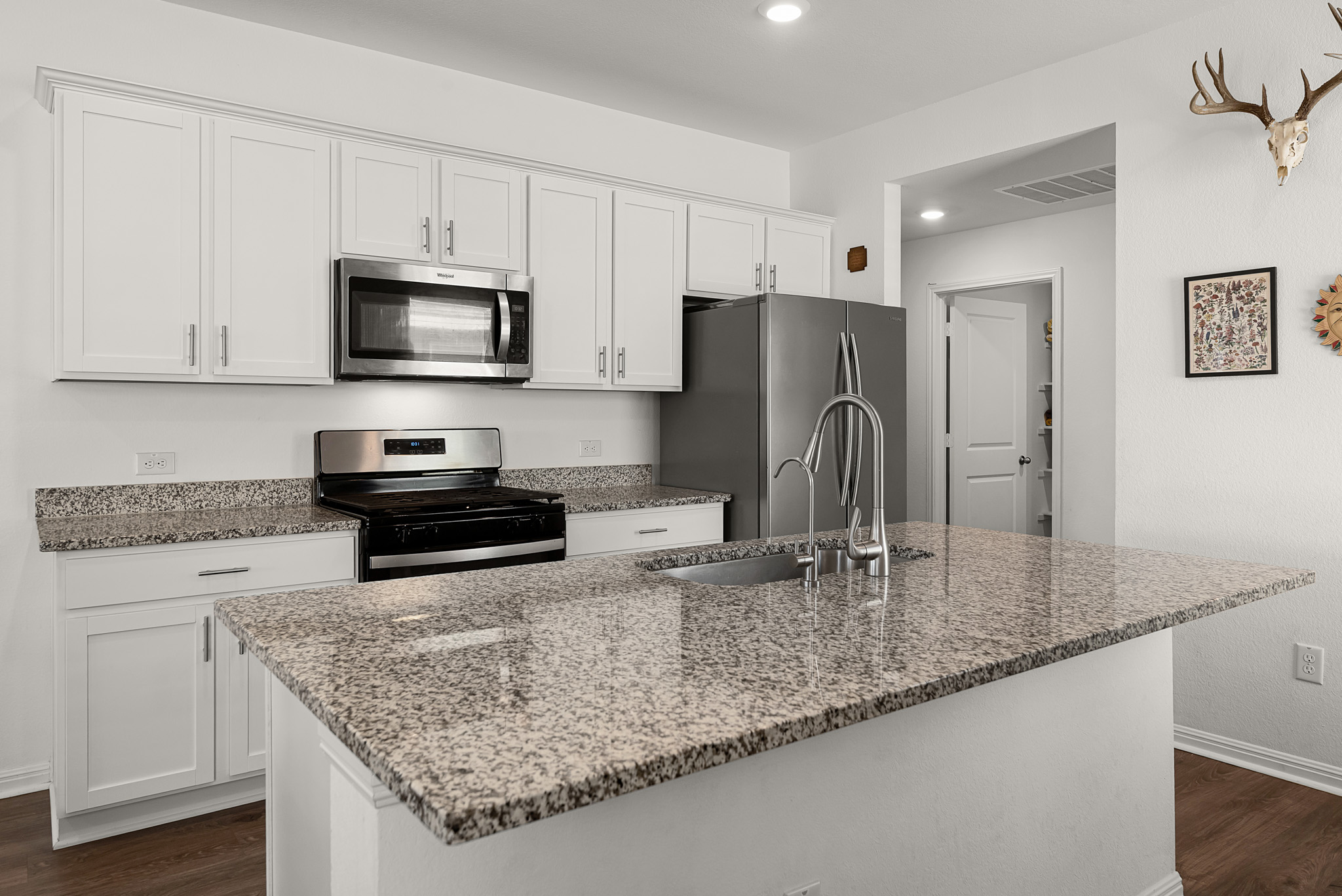 165 Santa Rosa Lane Buda, TX 78610 - Photo 5 of 21 a kitchen with stainless steel appliances granite countertop a sink stove and refrigerator