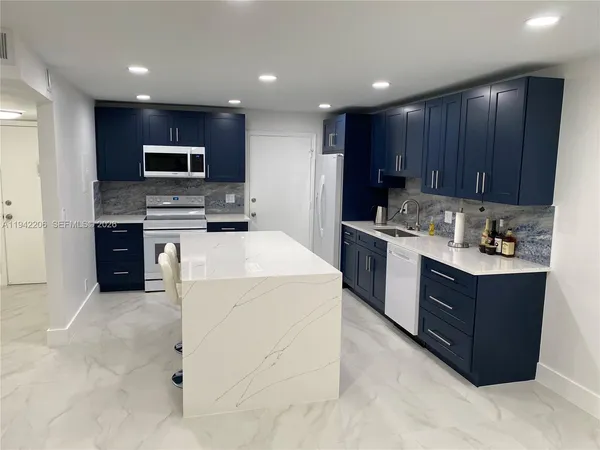 a kitchen with a stove sink and cabinets