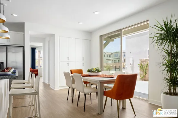 a dining room with furniture window and wooden floor