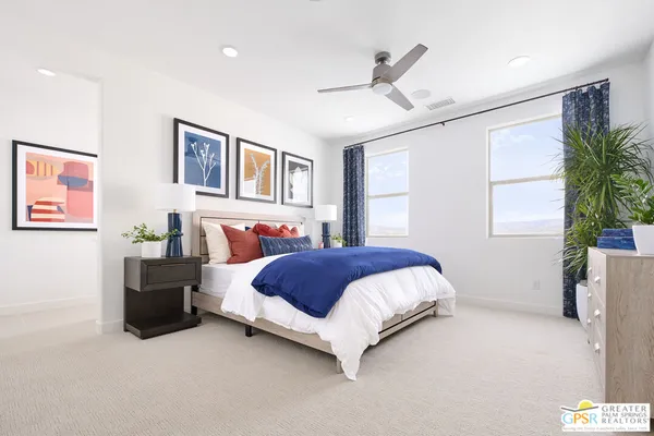a bedroom with a large bed and a chandelier
