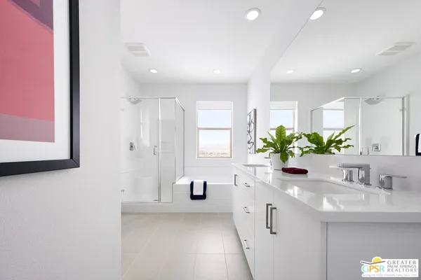 a bathroom with a sink a large mirror and a shower