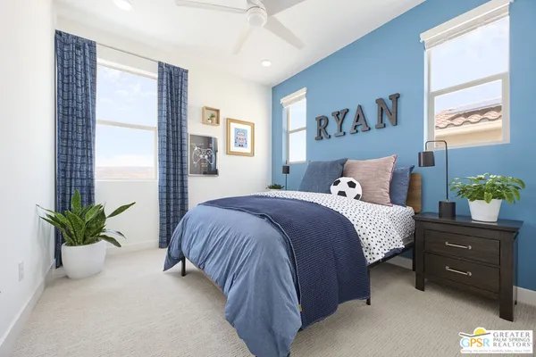 a bedroom with a bed and a potted plant