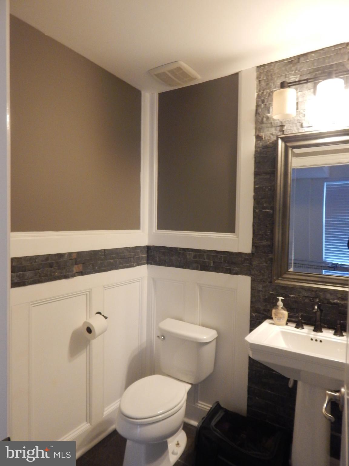 709 South Macon Street Baltimore, MD 21224 - Photo 3 of 8 a bathroom with a sink a toilet and shower