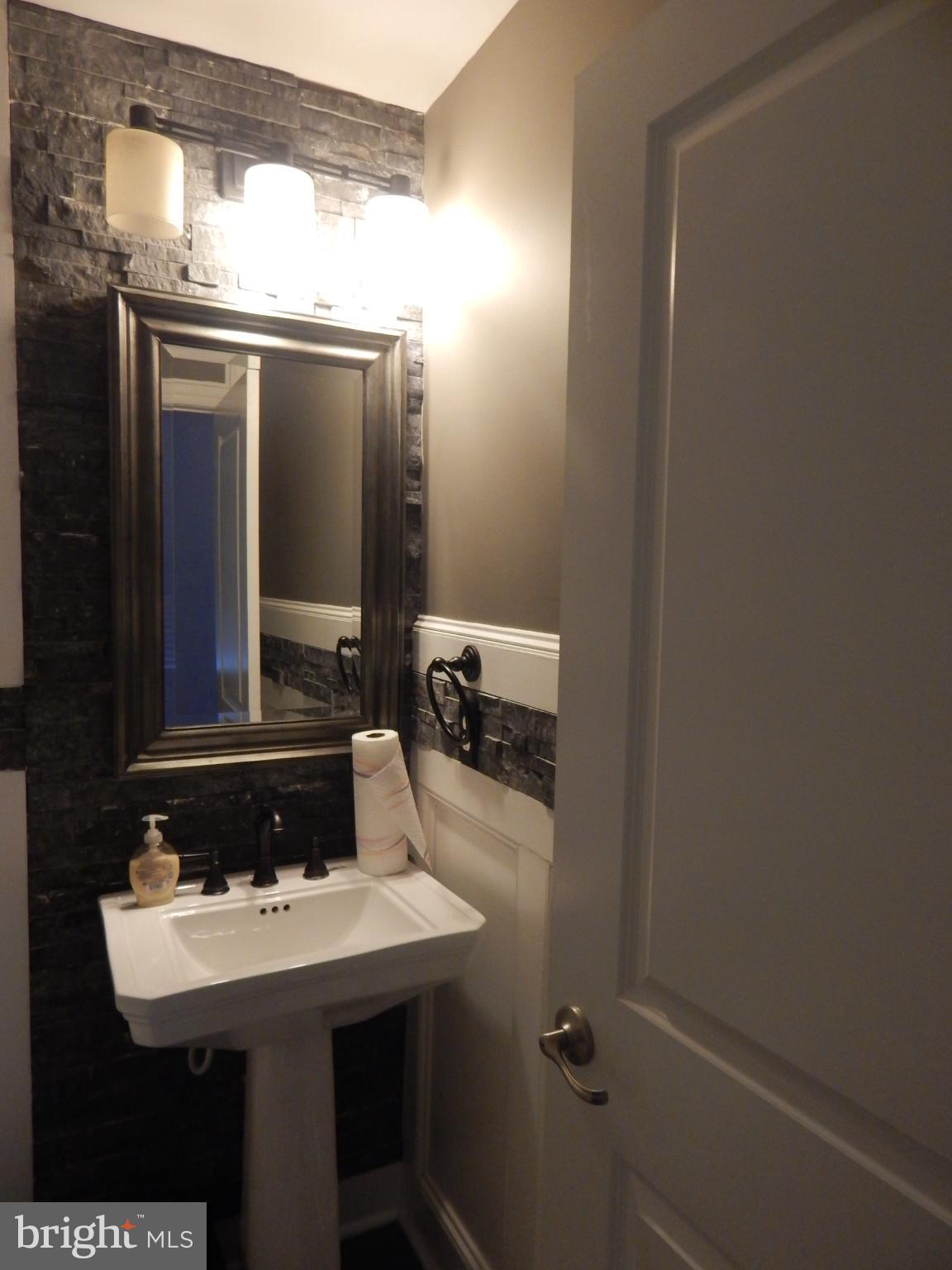 709 South Macon Street Baltimore, MD 21224 - Photo 4 of 8 a bathroom with a sink and mirror