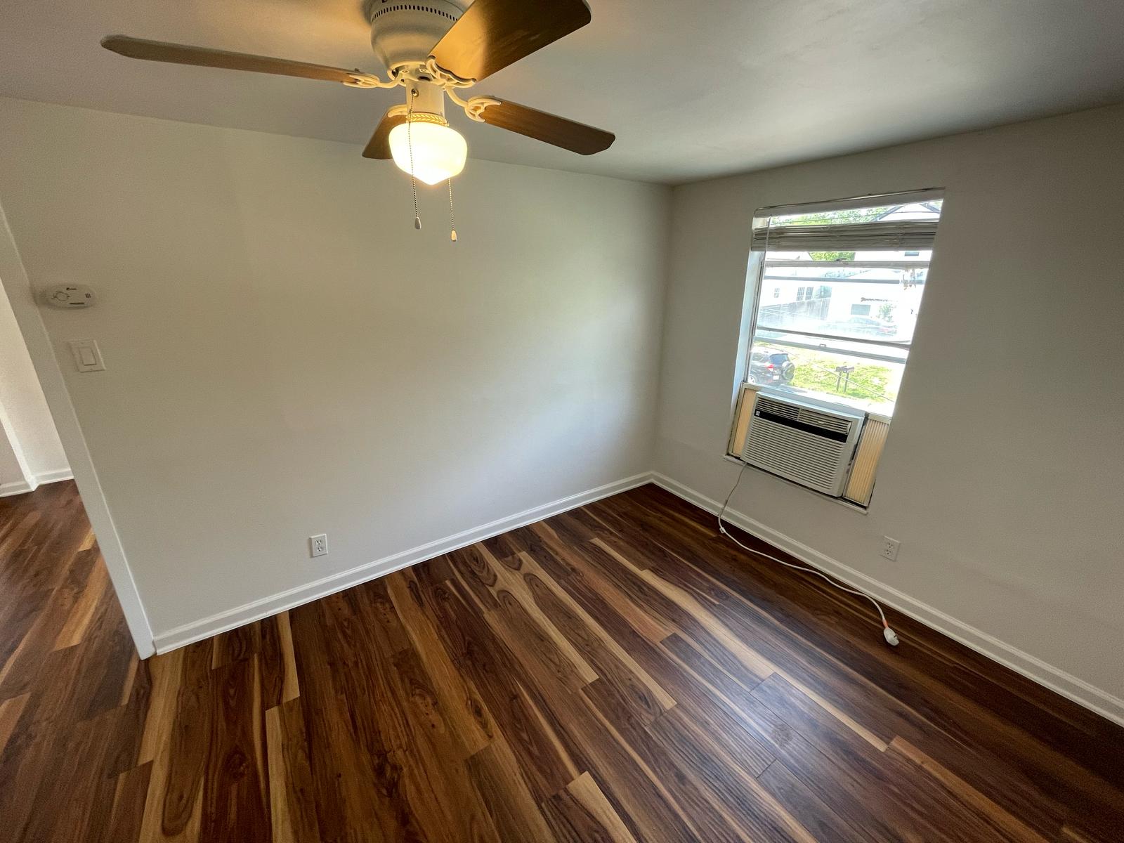 6404 Ponca Street, Unit B Austin, TX 78741 - Photo 7 of 17 wooden floor in an empty room