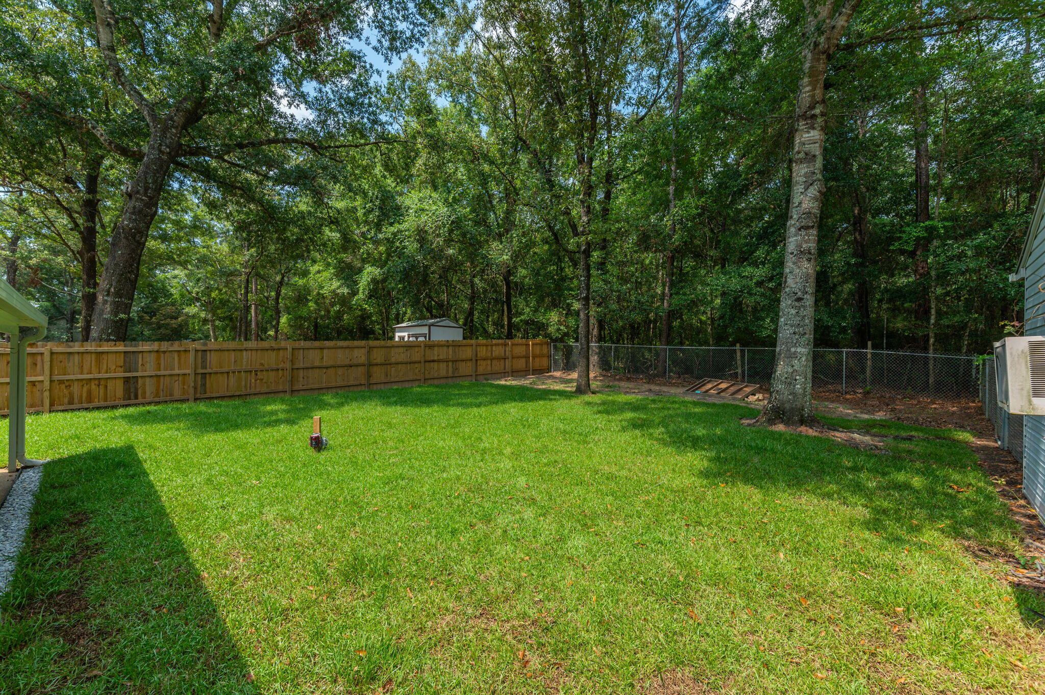 109 Beacons Bend Road Crestview, FL 32536 - Photo 9 of 35 a view of a yard with a wooden fence