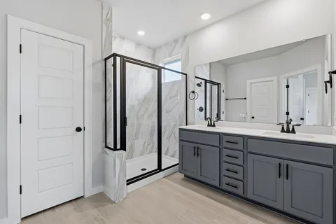 a bathroom with a double vanity sink mirror and