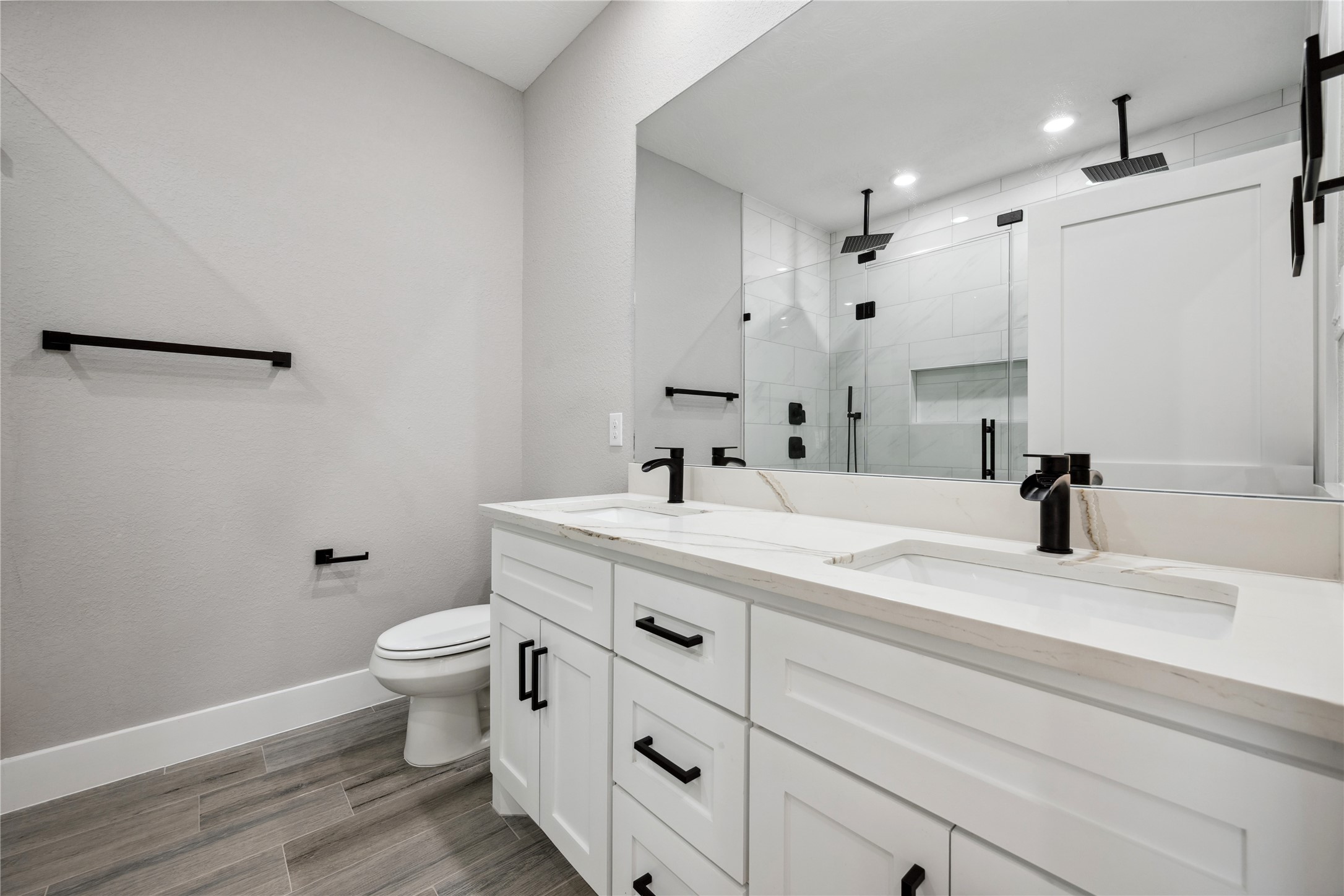 139 Popular Street Onalaska, TX 77360 - Photo 20 of 27 Primary bath has dual sinks, quartz countertops, upgraded faucets and fixtures and a large shower with dual rain heads.