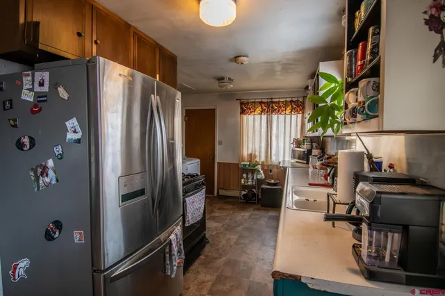a kitchen with stainless steel appliances a refrigerator and a stove