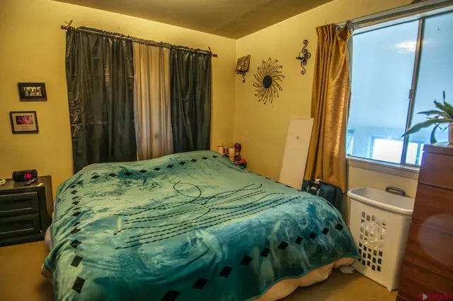 a bedroom with a bed and a mirror