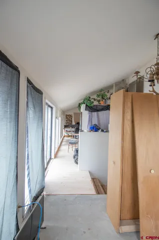 a bed room with a bed and a refrigerator