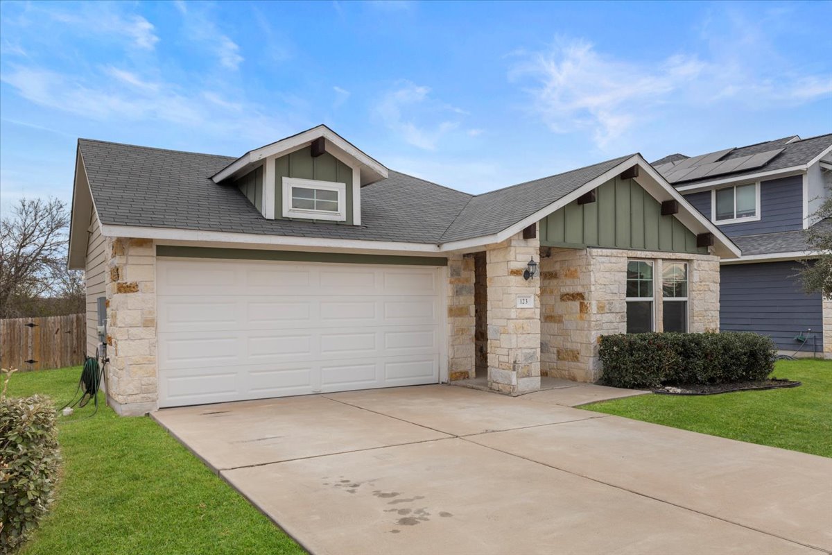 123 Saranac Drive Elgin, TX 78621 - Photo 3 of 27 Charming curb appeal welcomes you home with stone accents and a clean, well-maintained exterior.