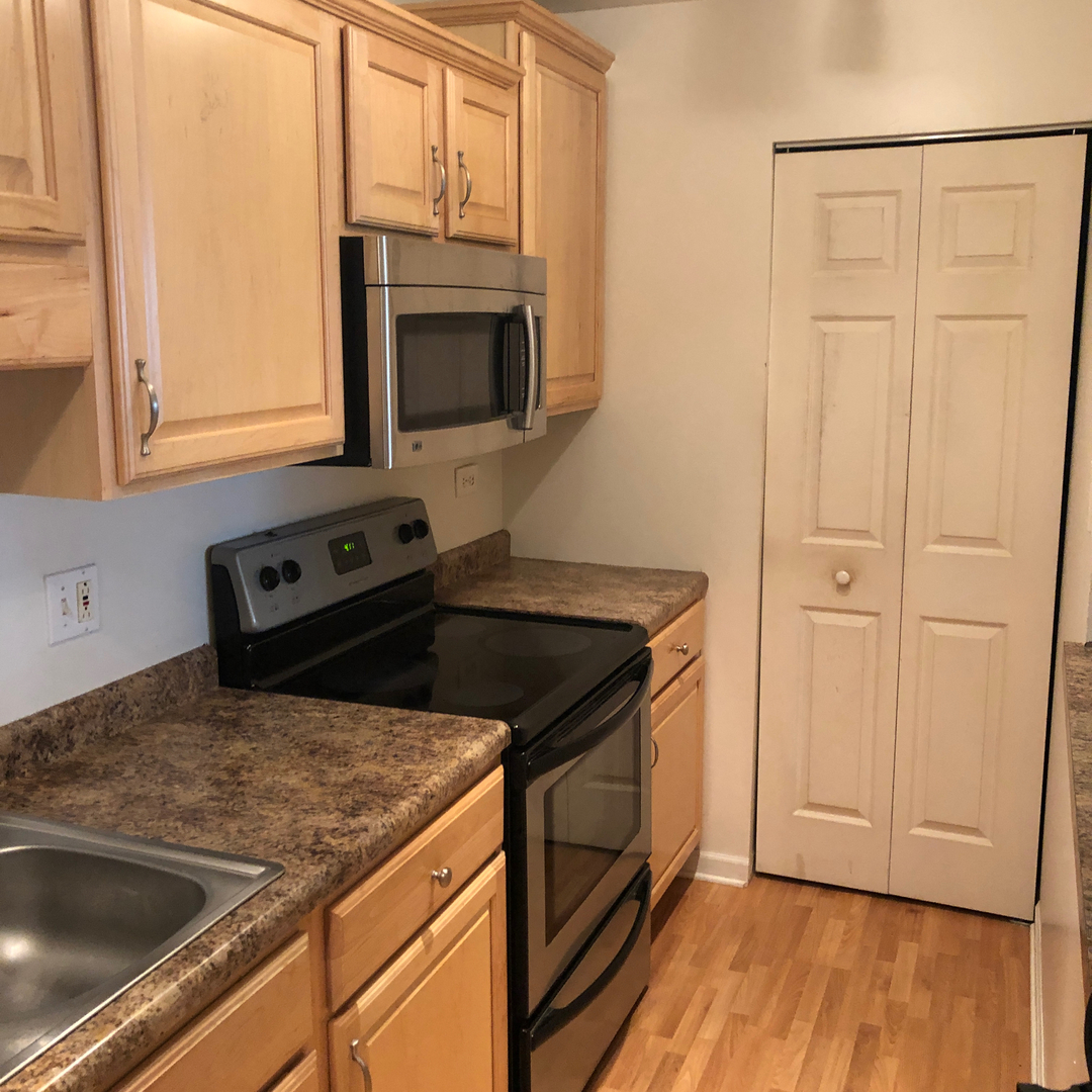 1969 North Hicks Road, Unit 102 Palatine, IL 60074 - Photo 4 of 17 a kitchen with granite countertop cabinets stainless steel appliances and a sink