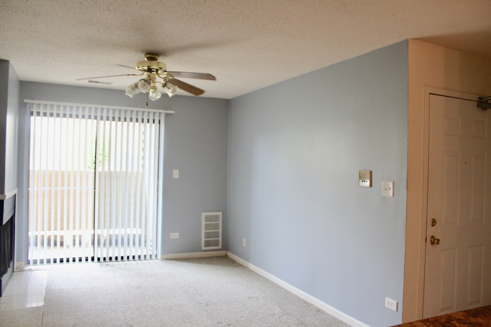 1969 North Hicks Road, Unit 102 Palatine, IL 60074 - Photo 5 of 17 a view of a livingroom with a chandelier fan and windows