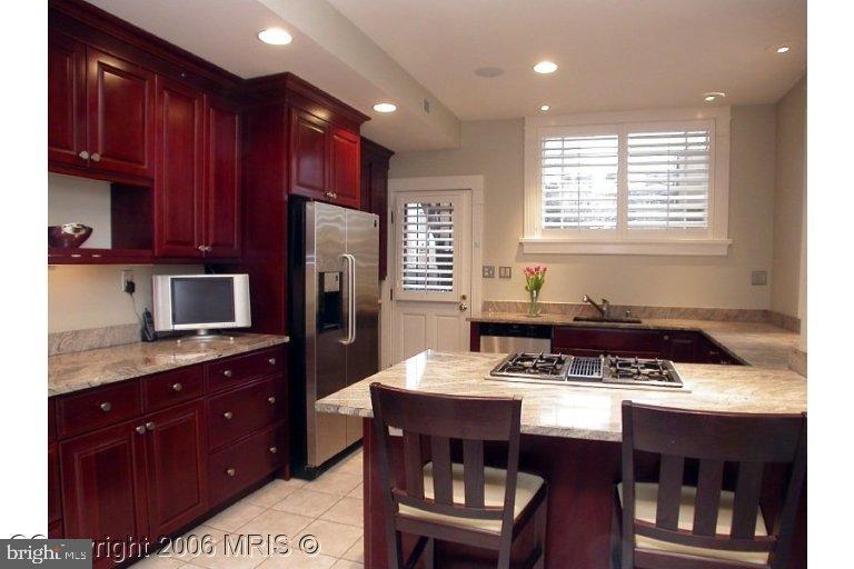 1905 16th Street Northwest Washington, DC 20009 - Photo 4 of 9 a kitchen with stainless steel appliances granite countertop a sink stove and refrigerator