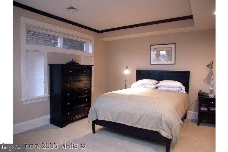 1905 16th Street Northwest Washington, DC 20009 - Photo 9 of 9 a bedroom with a bed and a wall painting