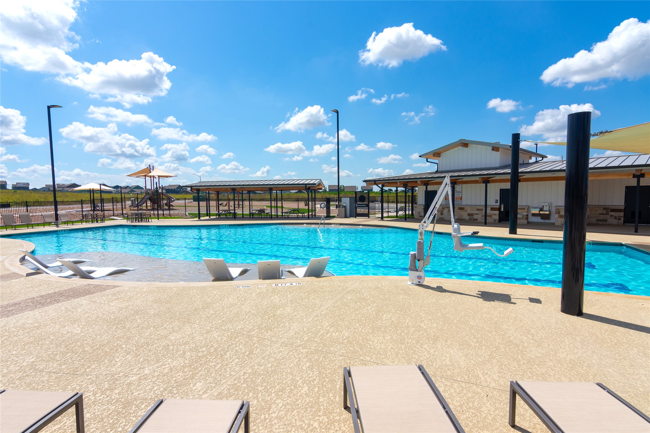 548 Rancho Del Cielo Loop Jarrell, TX 76537 - Photo 32 of 40 Expansive outdoor swimming pool with integrated seating and a broad deck