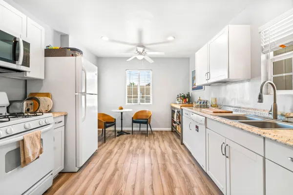 a kitchen with a sink stove and refrigerator