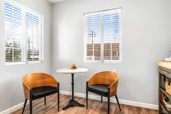 a view of a workspace with furniture and a window