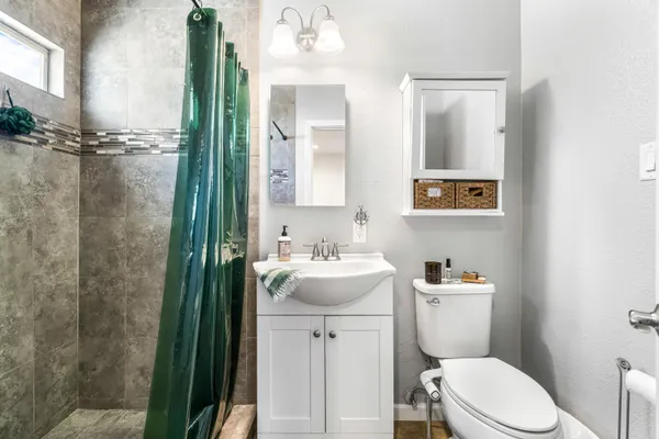 a bathroom with a sink a mirror and shower