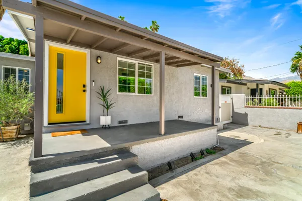 a front view of house with outdoor seating
