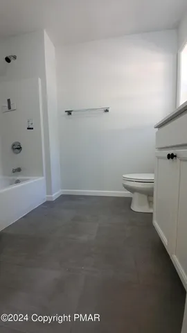 a bathroom with a toilet a sink and shower
