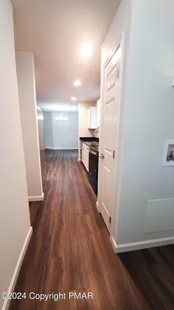 a view of a kitchen from a hallway