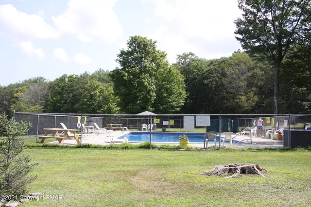 a view of a swimming pool with a table and chairs