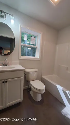 a bathroom with a toilet a sink and a bathtub