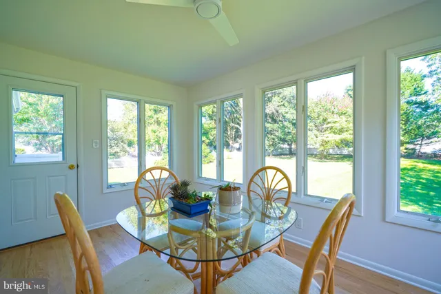 a dining room with furniture window and wooden floor