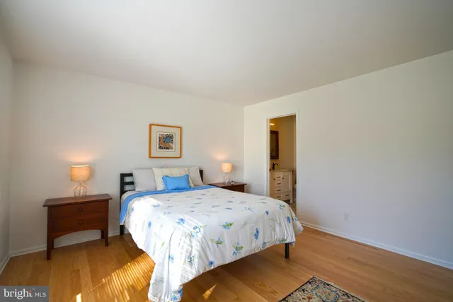 a bedroom with a bed and a night stand