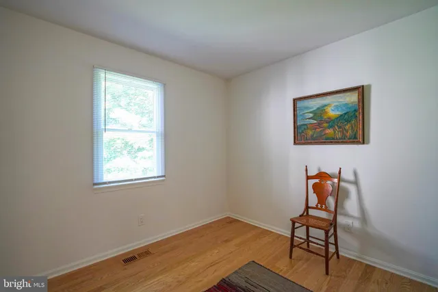a workspace with wooden floor and a bookshelf