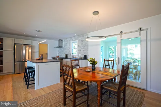 a dining room with furniture and wooden floor