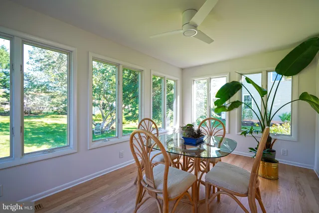 a dining room with furniture window and wooden floor