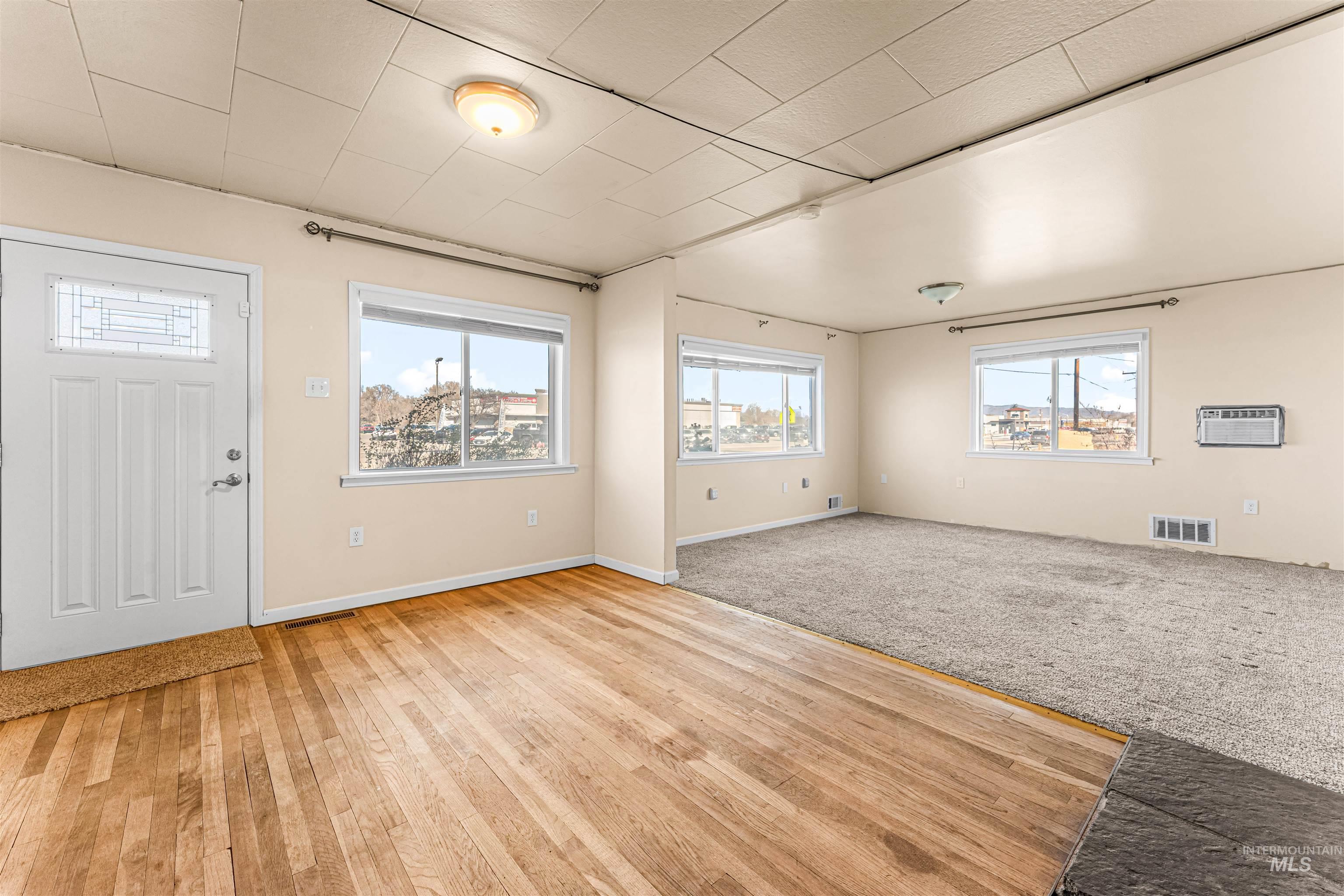 1115 Airbase Road Mountain Home, ID 83647 - Photo 17 of 32 Entryway with light colored carpet and a wall unit AC