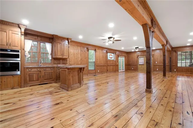 a spacious bedroom with a bed couch and a window