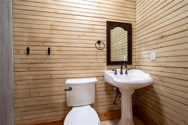 a view of an empty room with wooden floor and windows