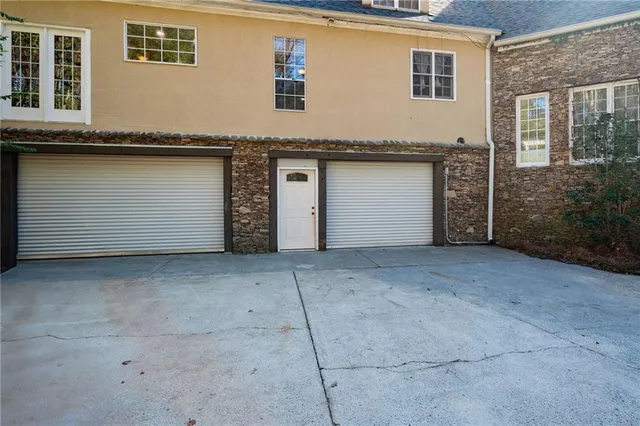 a backyard of a house with table and chairs