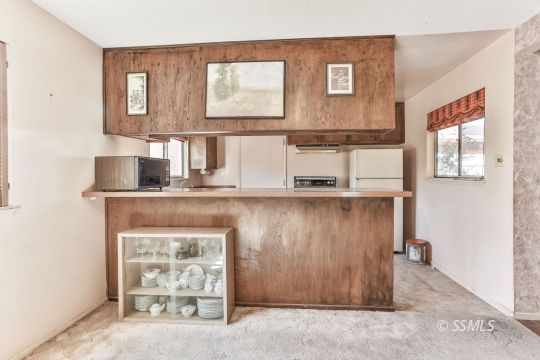 242 Peg Street Ridgecrest, CA 93555 - Photo 6 of 32 a kitchen with cabinets and window