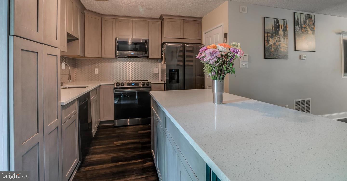 2132 Cartwright Place Reston, VA 20191 - Photo 11 of 21 a kitchen with sink refrigerator and stove