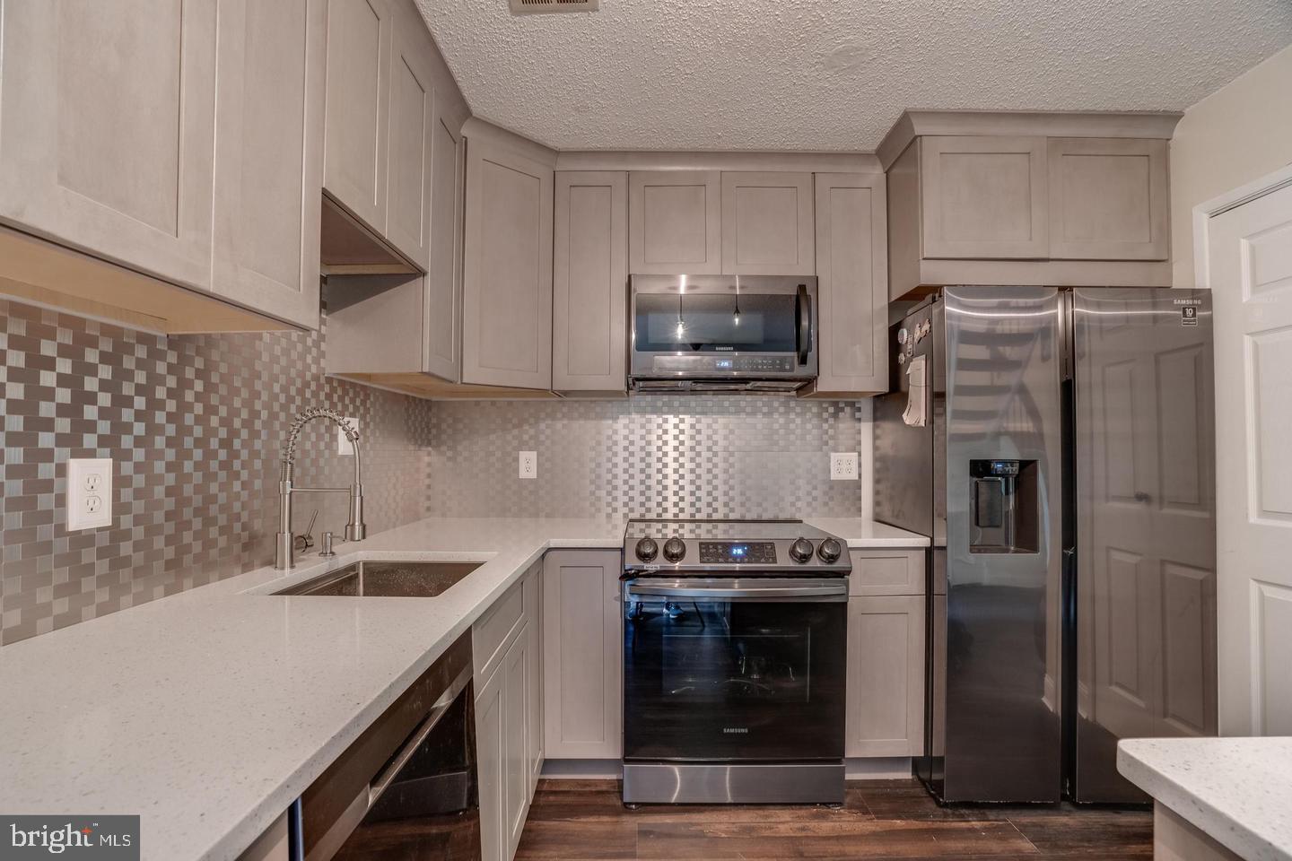 2132 Cartwright Place Reston, VA 20191 - Photo 9 of 21 a kitchen with a sink stove and refrigerator