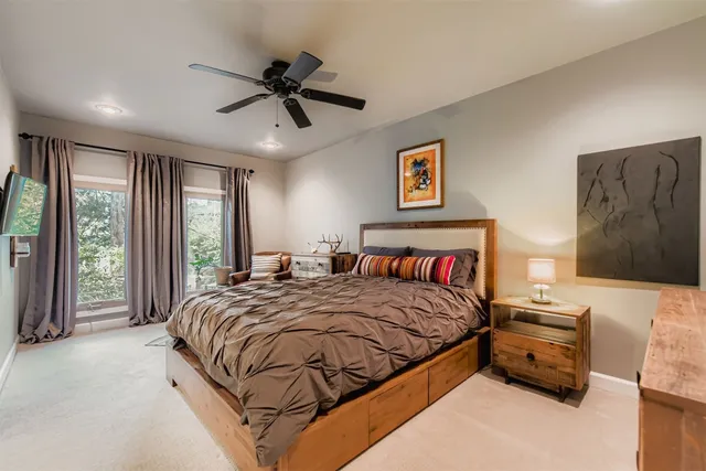 a bedroom with a bed and a large window