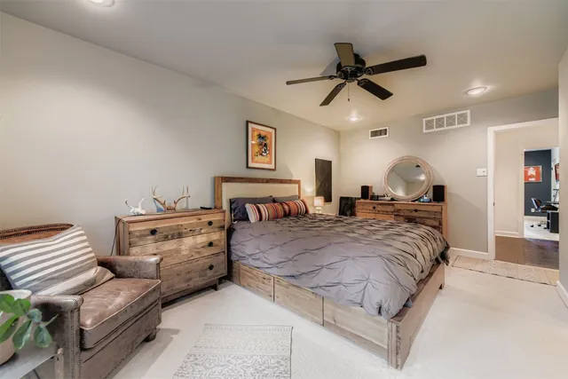 a bedroom with a bed and ceiling fan