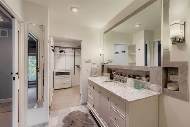 a spacious bathroom with a granite countertop sink mirror and double