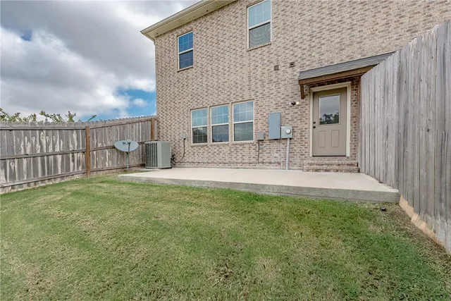 a front view of a house with a garden and yard