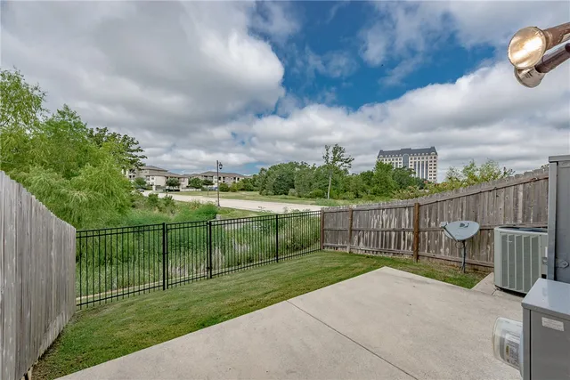 a view of a backyard with wooden fence