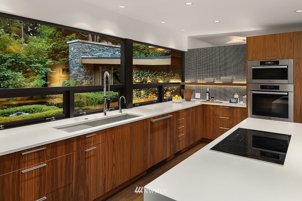 1249 Evergreen Point Road Medina, WA 98039 - Photo 14 of 40 a kitchen with a sink a counter top space stainless steel appliances and a large window