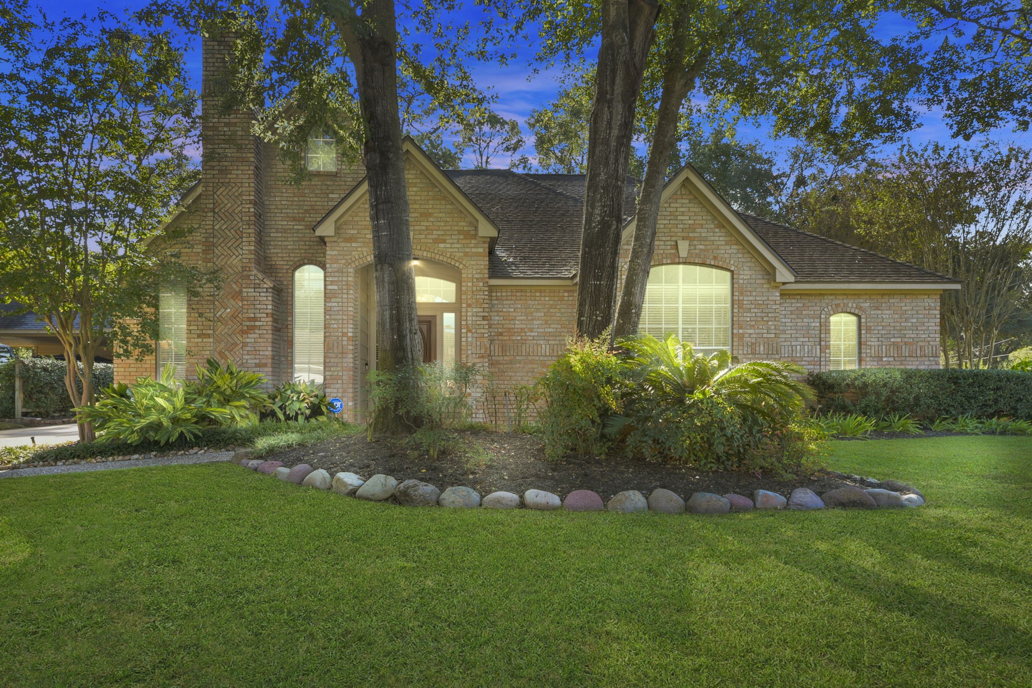 a front view of a house with a garden