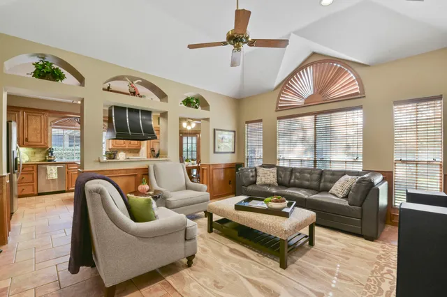 a living room with furniture ceiling fan and a rug