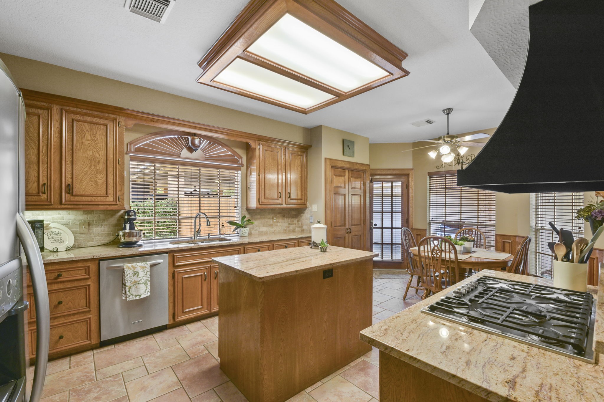 5827 Ashmere Lane Spring, TX 77379 - Photo 21 of 50 a kitchen with stainless steel appliances granite countertop a sink stove and refrigerator